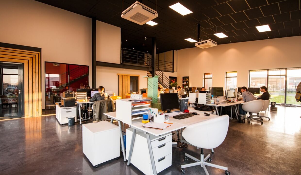 Modern open-plan office with employees working at desks