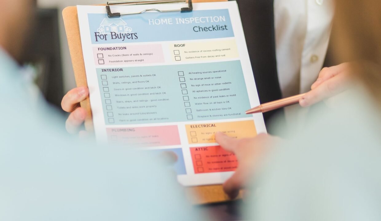 Hands holding a property inspection checklist on a clipboard